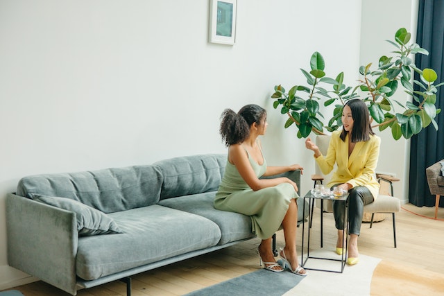 two-tenants-sitting-on-couch-in-rental-property